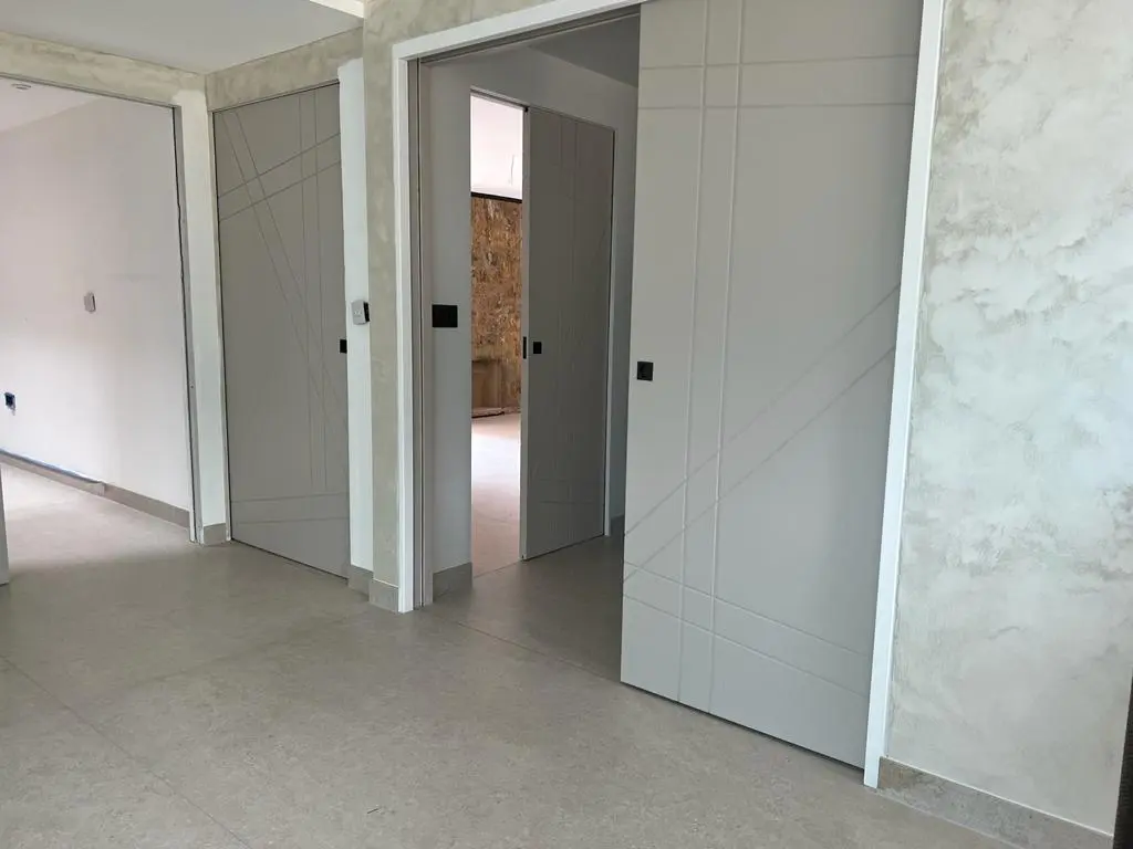 Painted sliding modern pocket doors being installed bespoke internal doors near me