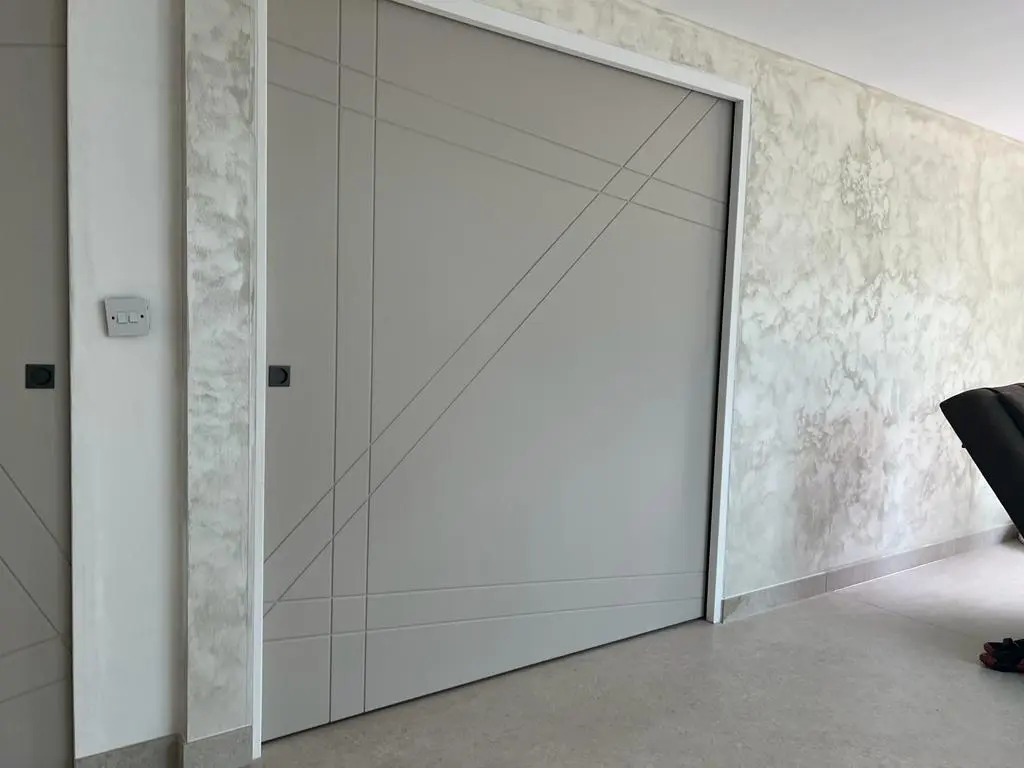Painted sliding modern pocket doors being installed bespoke internal doors