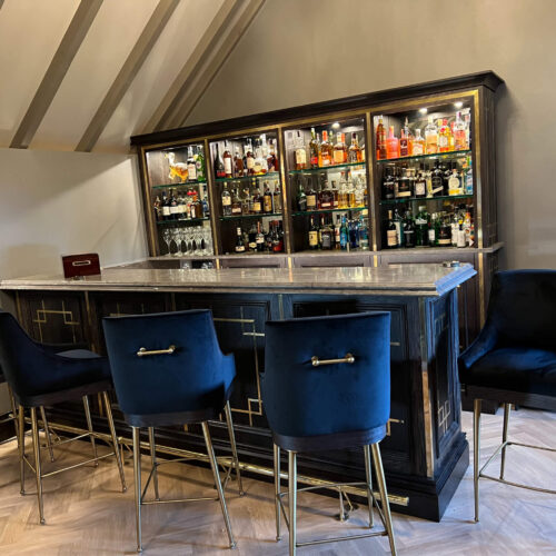 Bar & back fitting in stained oak with brass inlays, antique mirrors, granite tops