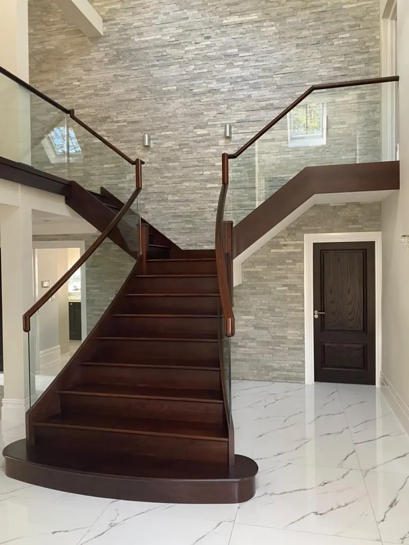 Curved closed string stair in Walnut